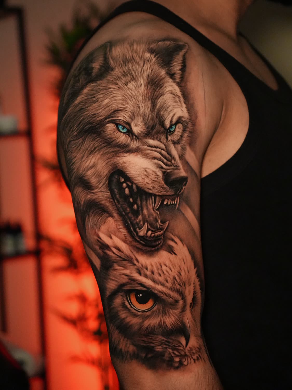 Black-and-grey realism wolf and owl sleeve by Sahil Verma
