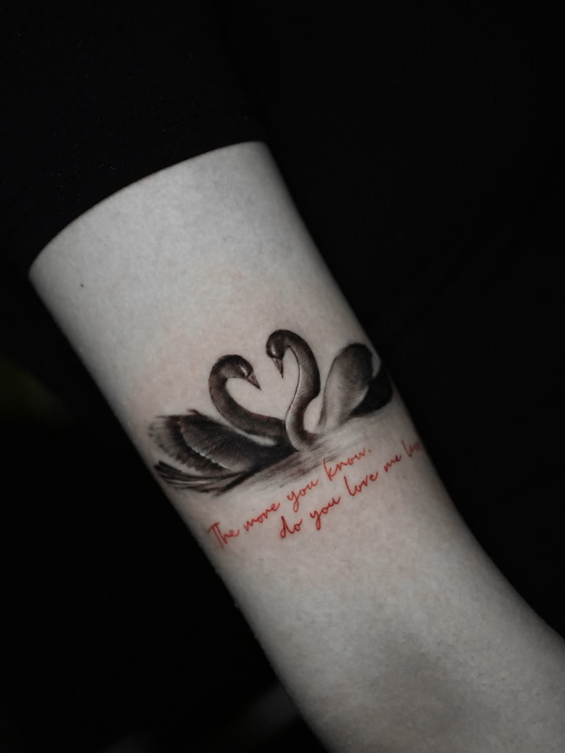 Fine-line peacock feather with script tattoo