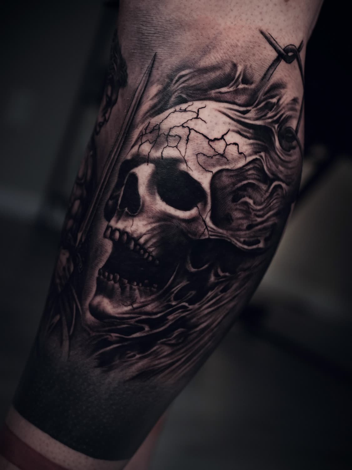 Cracked skull with smoke, black and grey realism