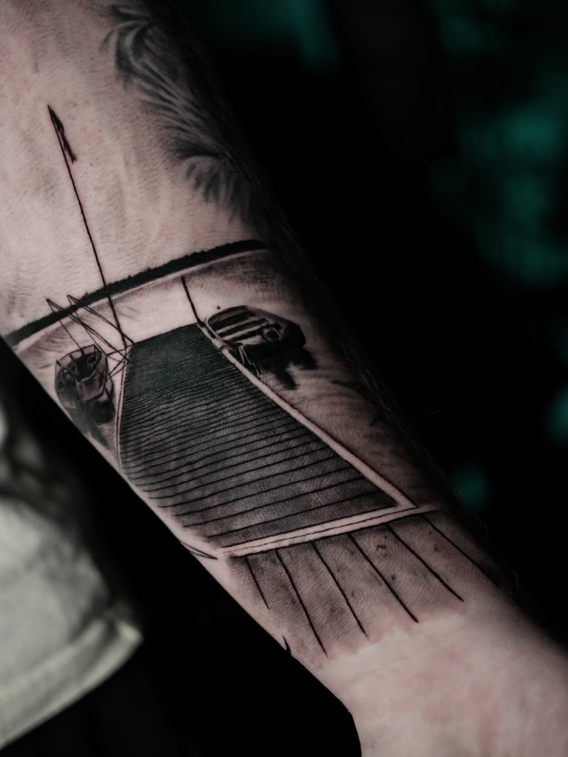 Black and grey lake, dock and boats scenery tattoo