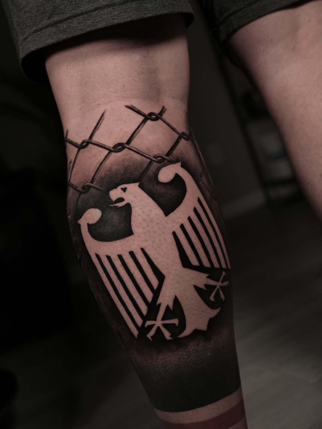 Bold blackwork German eagle crest with barbed wire
